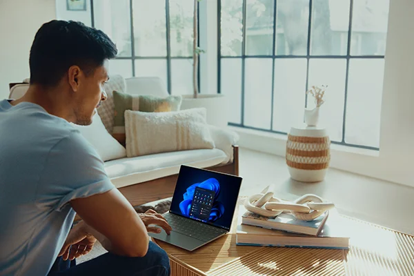 man looking at laptop in living room