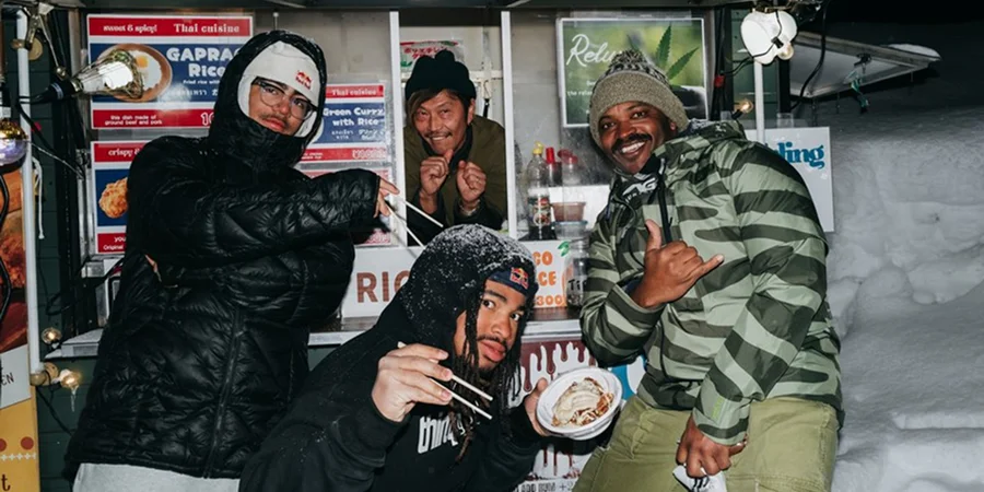 Burton riders eating ramen at a food stall in Japan