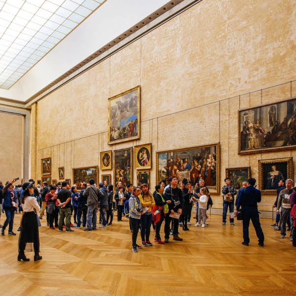 Museum visitors admire art displayed on the walls
