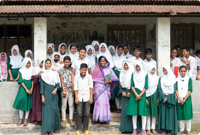 A group photo of Kabita and her students outside the school.