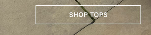 White button with "SHOP TOPS" text, centered on a textured tan stone background with dark lines. Discover stylish women's tops.