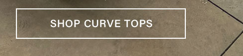 White outlined button on a textured brown background displays "SHOP CURVE TOPS", prompting users to discover stylish curve tops.