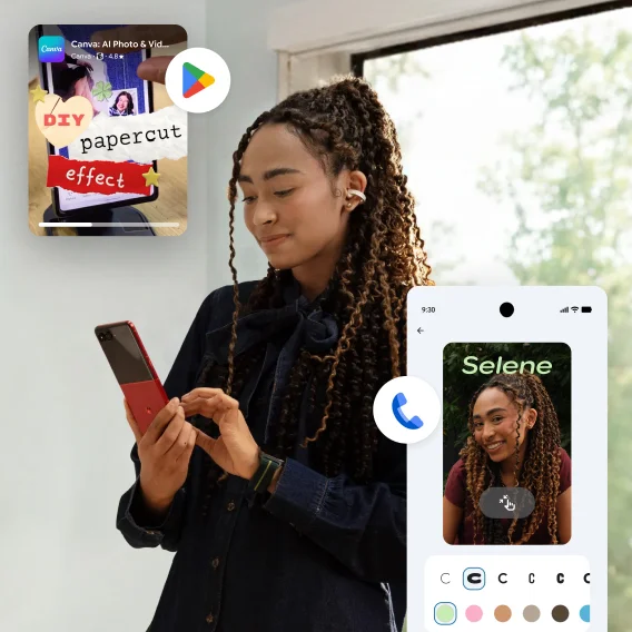 A woman standing in front of a window looking at a smartphone