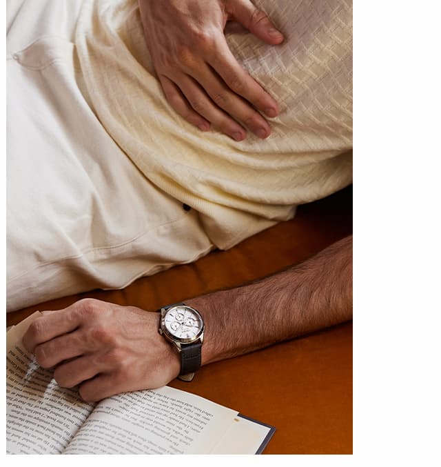 Man wearing a Rolan and reading a book.