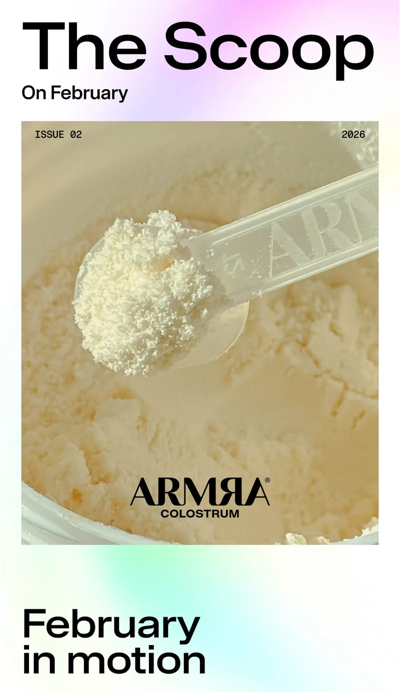 The Scoop / On February / ISSUE 02 / 2026 / ARMRA COLOSTRUM / February in motion. Scoop of ARMRA powder over open container.