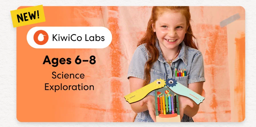 Young girl smiling while working on a science experiment from KiwiCo Labs. Hands-on STEM learning for ages 6–8.