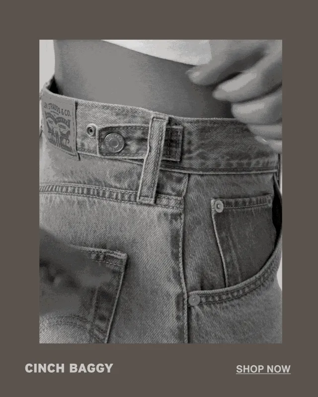 Person cinching their jeans.