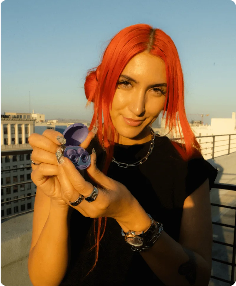 A red hair woman showing Loop x Tomorrowland limited edition.