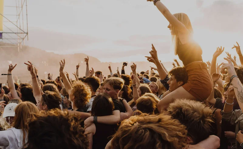 A crowd of people dancing at a festival.
