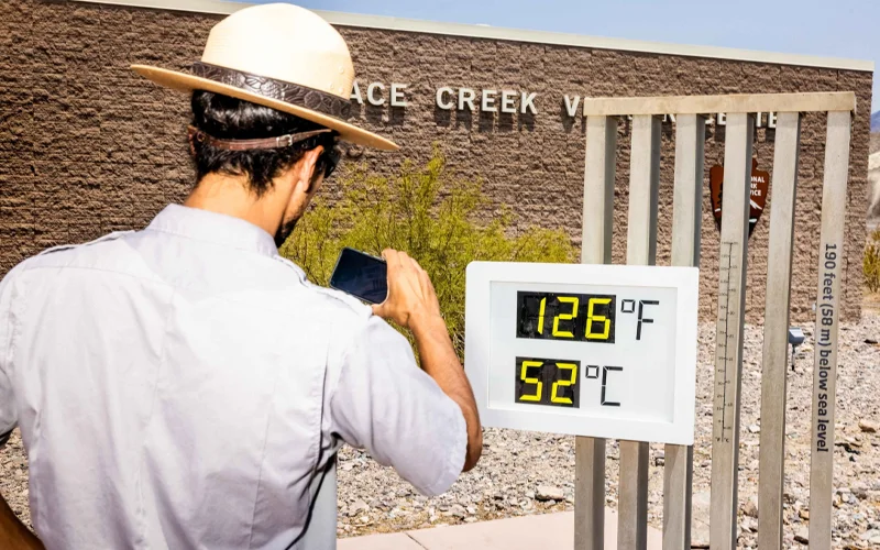 A park ranger takes a photo of a thermometer at California’s Death Valley National Park in 2021. Metric was officially declared America’s preferred system of measurement in 1975, but the U.S. public has been slow to embrace it.