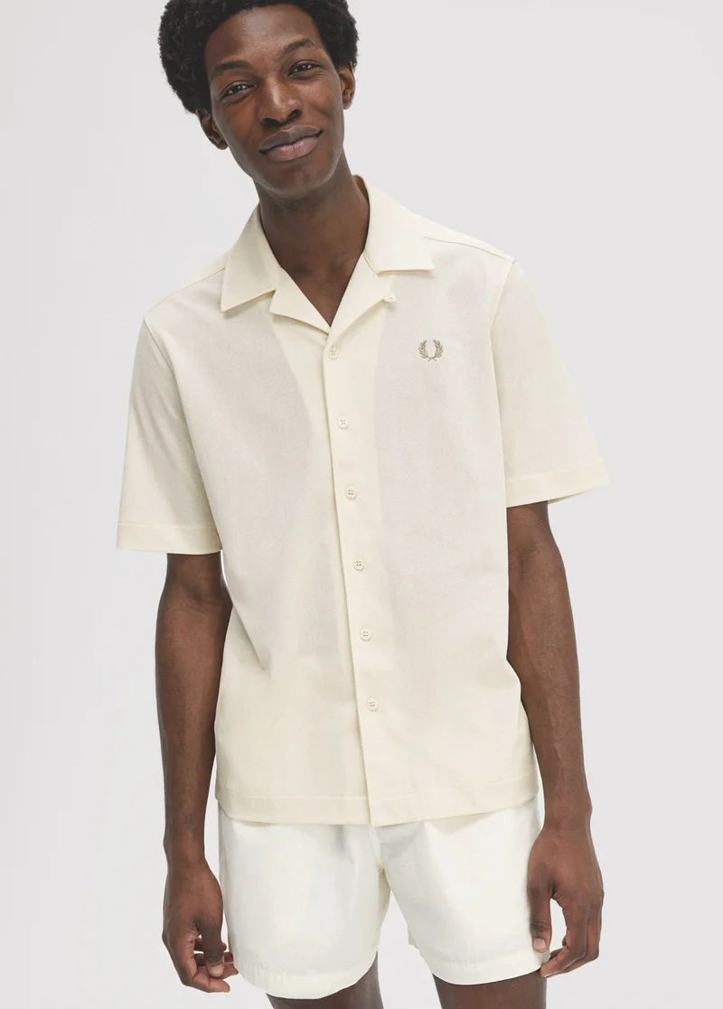 Male model wearing a woven ecru short sleeved shirt