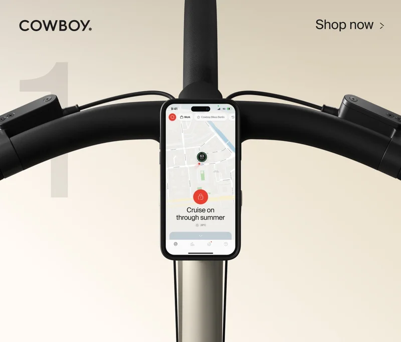 A graphic composition. A render of a Cowbiy Cruiser bike, seen from a low front-on angle, is positioned over the number 10. The Cowboy logo is in the top left and a Shop Now CTA in the top right corner.
