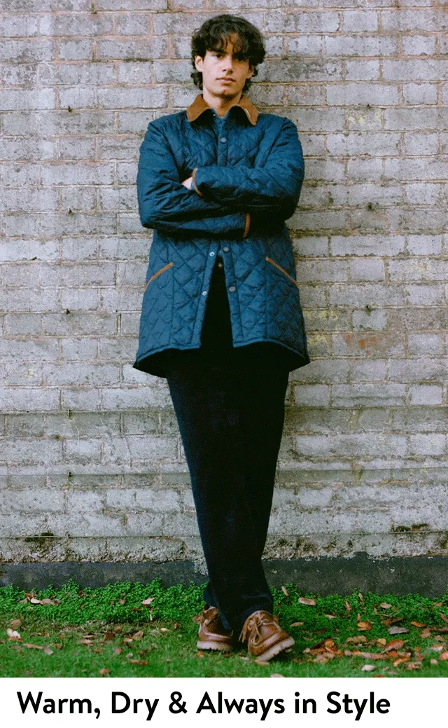 A man wearing a quilted Barbour jacket.