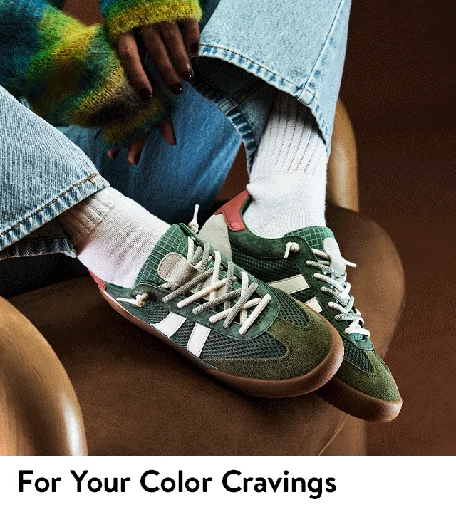 Women wearing orange and green sneakers.