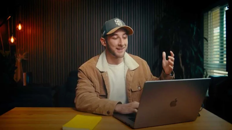 Sam Newton explaining the concepts of filmmaking behind a computer.