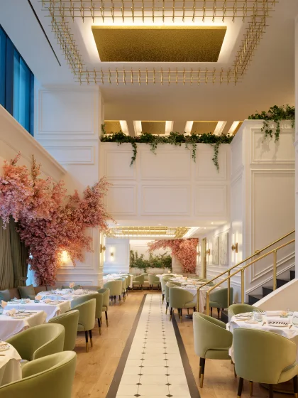 A sophisticated dining room with high ceilings and florals.