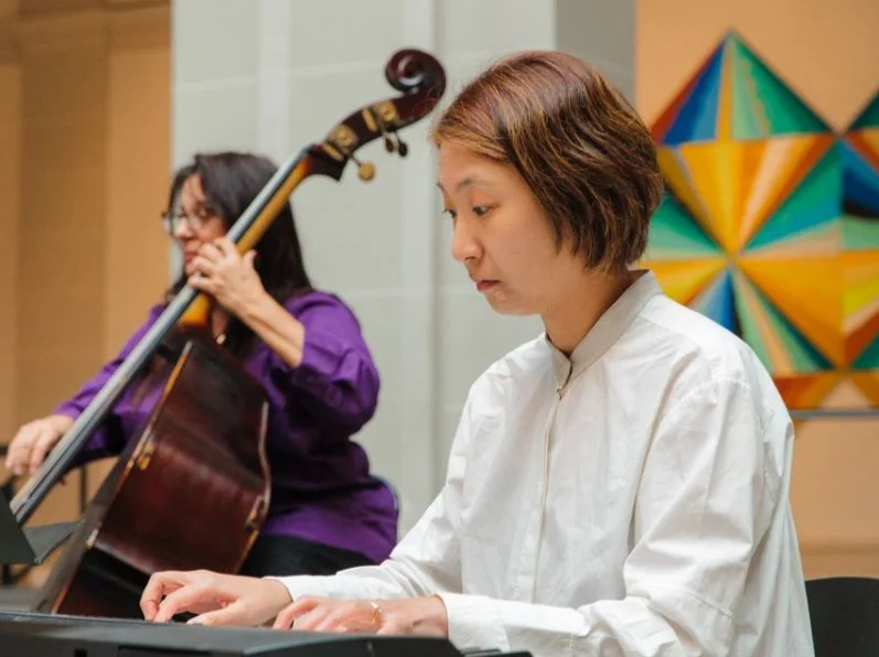 Performers playing a keyboard and a double bass