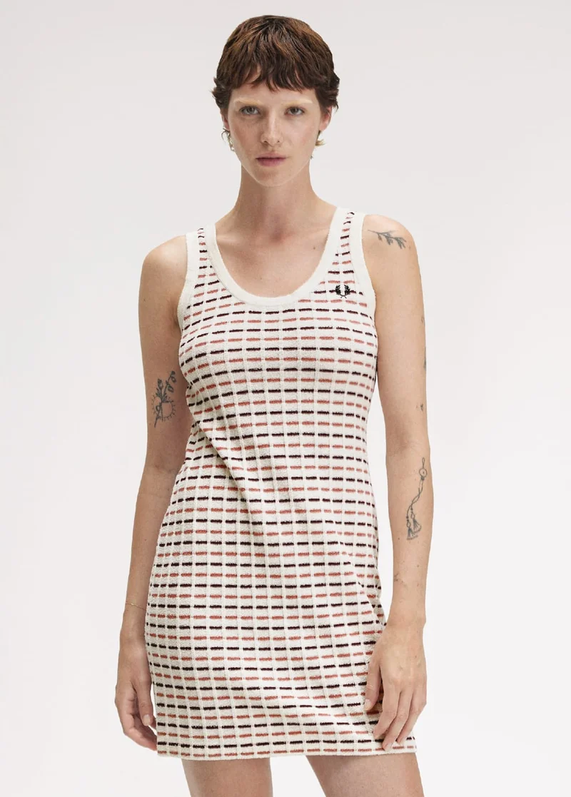 Short haired white woman wears textured mini dress with scoop neck