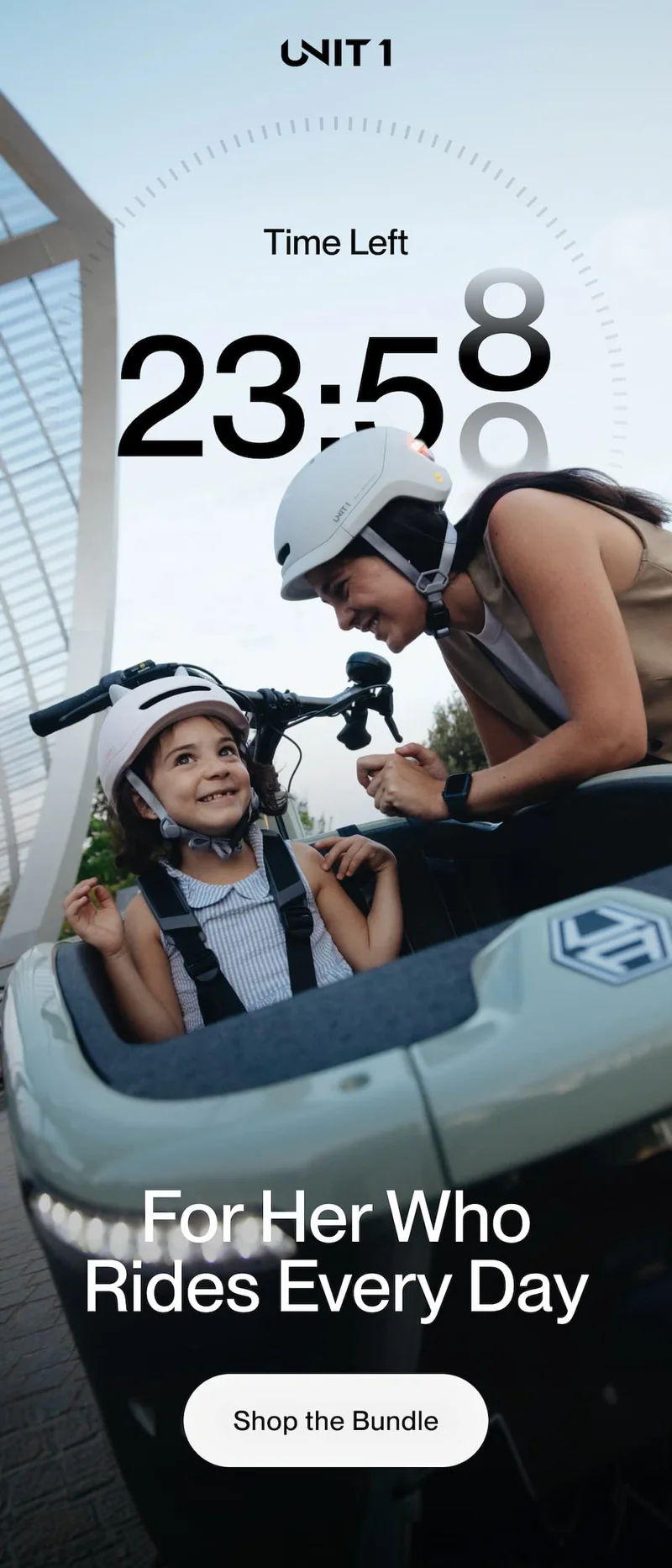 Mom smiling at her young daughter seated in a cargo bike front seat, both wearing white helmets — Unit 1 bundle sale countdown offer.
