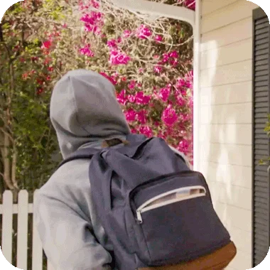 Burglar looking at a house.