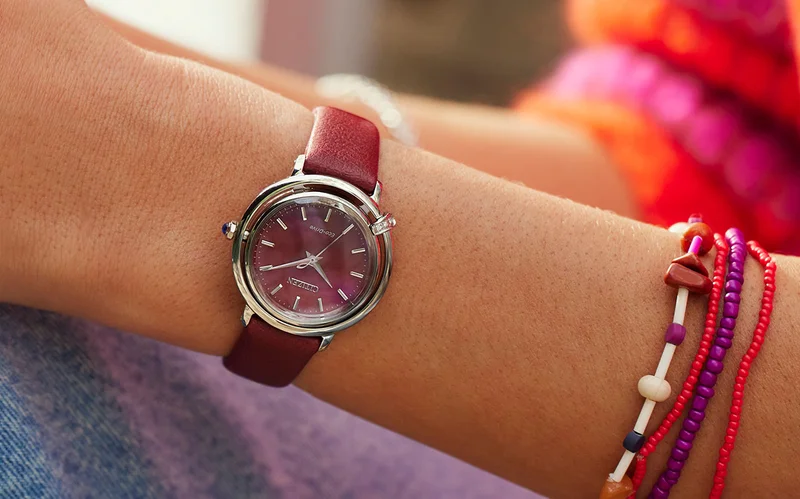 A woman wearing Citizen ruby watch