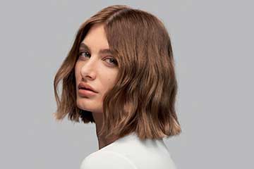 Model with light brown hair styled into a textured bob.