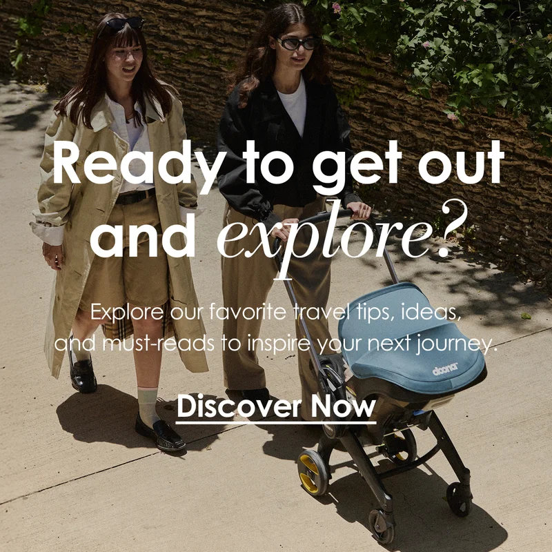 Woman pushing a Doona Car Seat & Stroller outdoors with another woman walking beside her.