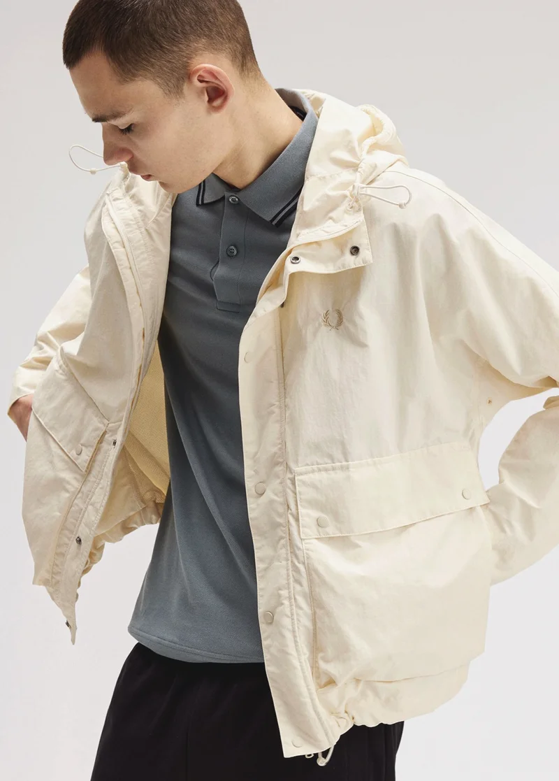 Male model wearing a Cropped Ripstop Parka in Ecru