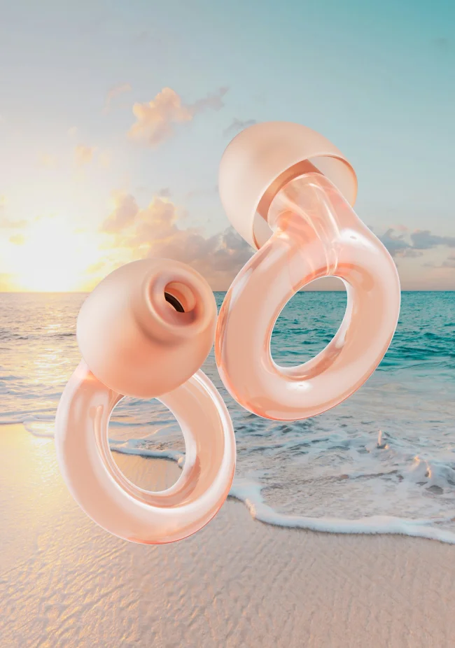 A set of Rose Loop Engage earplugs in front of an ocean backdrop.