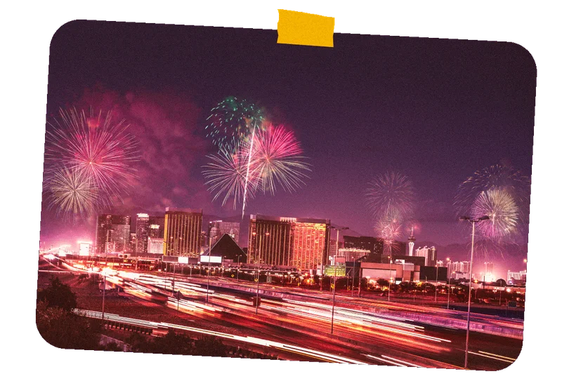 Image Description: A long exposure shot of colorful fireworks above The Strip in Las Vegas