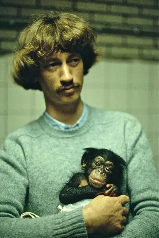 Frans de Waal holds a young chimpanzee at the Burgers' Zoo in the Netherlands, in 1979, where he begins his primate studies.