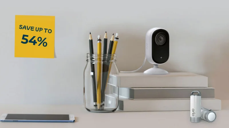 Save up to 54%. Arlo Essential Indoor Camera and Arlo Safe Button Accessories on a desk.