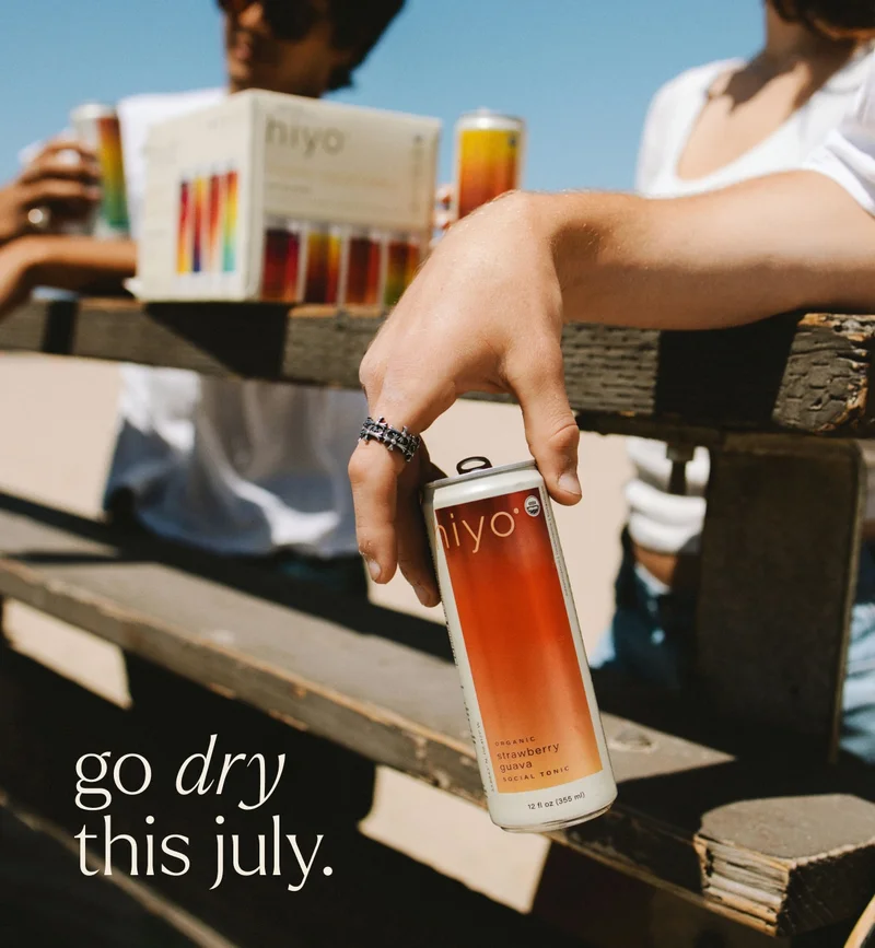 bevs for the break. closeup of strawberry guava hiyo held by friends hanging out at the pier.