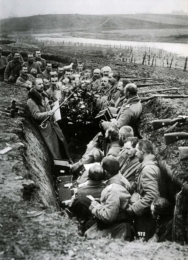 In the early months of the war, soldiers decorate their trench with fir trees.