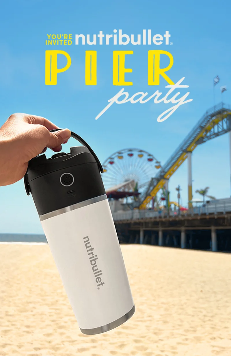 White nutribullet Flip with pier and the beach in the background