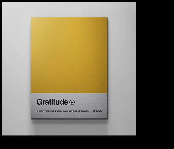 Minimal wall art titled “Gratitude®” with a golden yellow top section and a grey base reading “Golden yellow for presence and earned appreciation.”