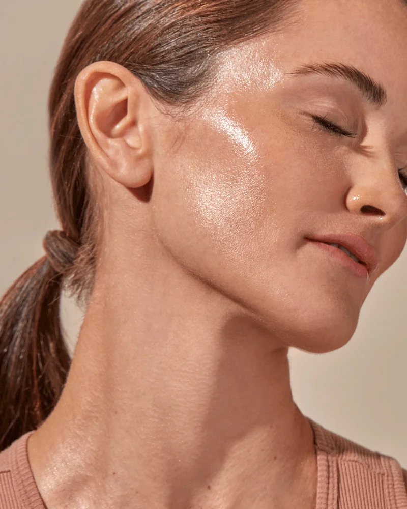 Beautiful woman displaying her glowing radiant skin.