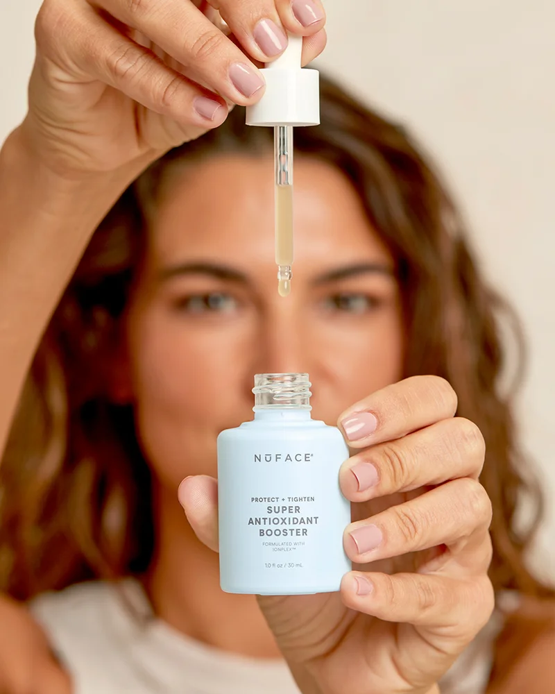 Beautiful woman dispensing Super Antioxidant Booster