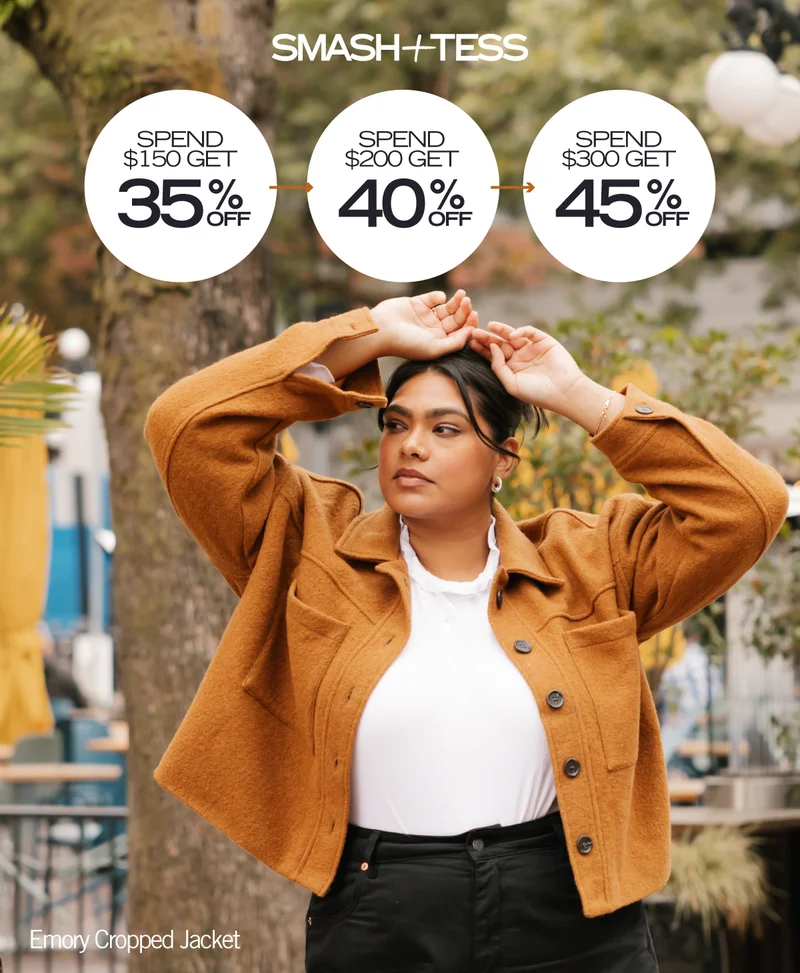 woman wearing mustard wool jacket with spend and save promotion text overlaid