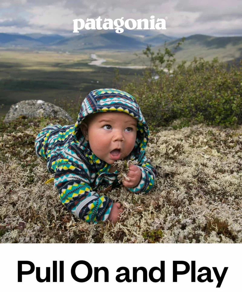 A baby does tummy time on the tundra.