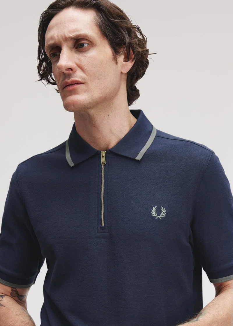 Male model wearing a Fred Perry Crepe Pique Polo Shirt in Dark Airforce
