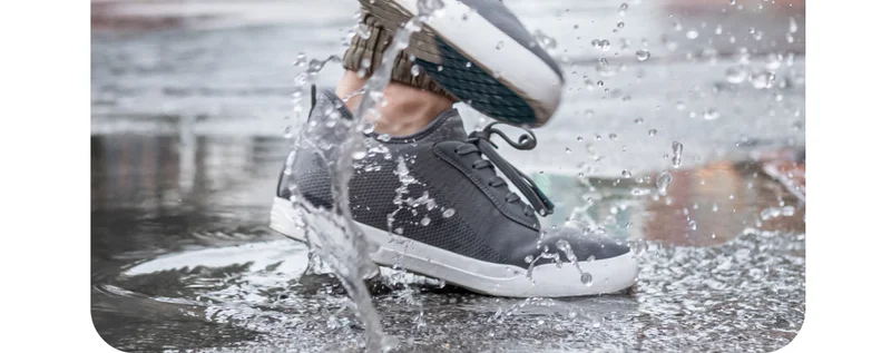 Graphic of someone wearing their Weekend Sneakers in a puddle.
