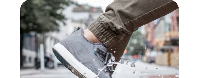 Graphic of someone wearing their Weekend Sneakers in a puddle.