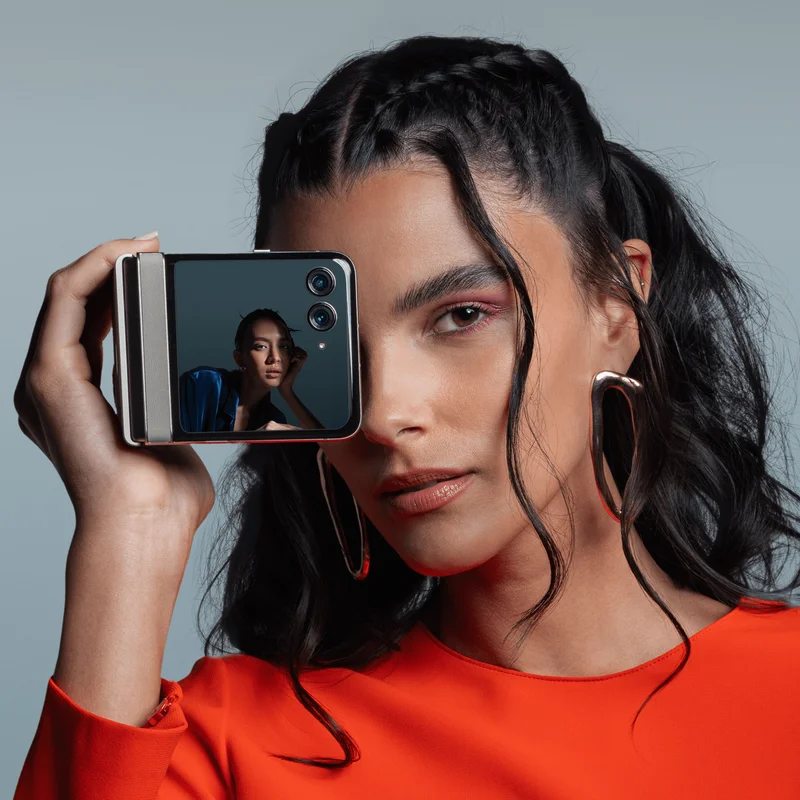 A person taking a picture with the motorola razr - 2024
