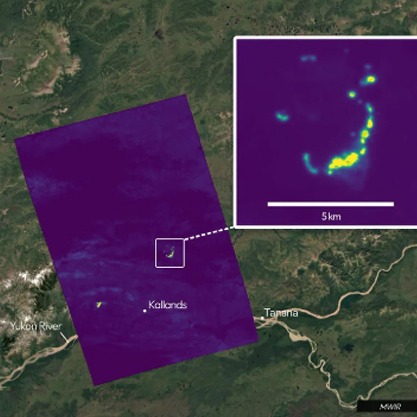 Satellite view of rivers with purple thermal data highlighting bright yellow-green hotspots, including a magnified 5 km arc of intense heat