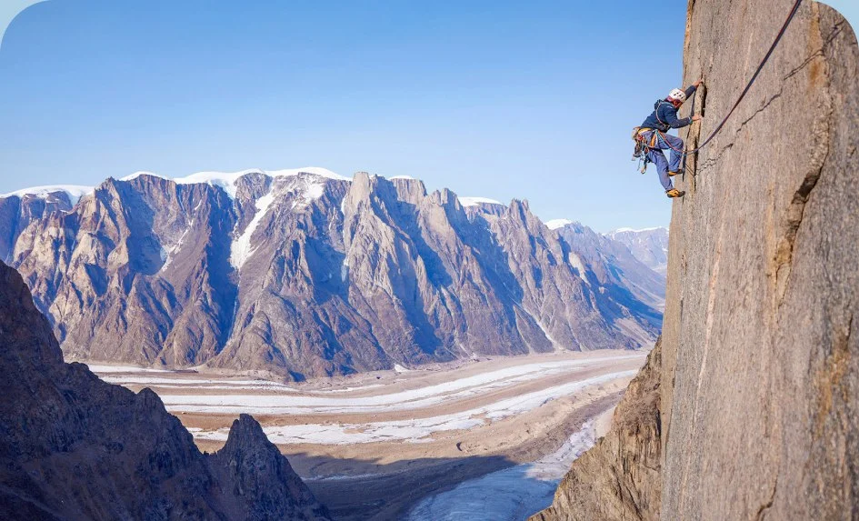 A climber on a sheer rock wall.