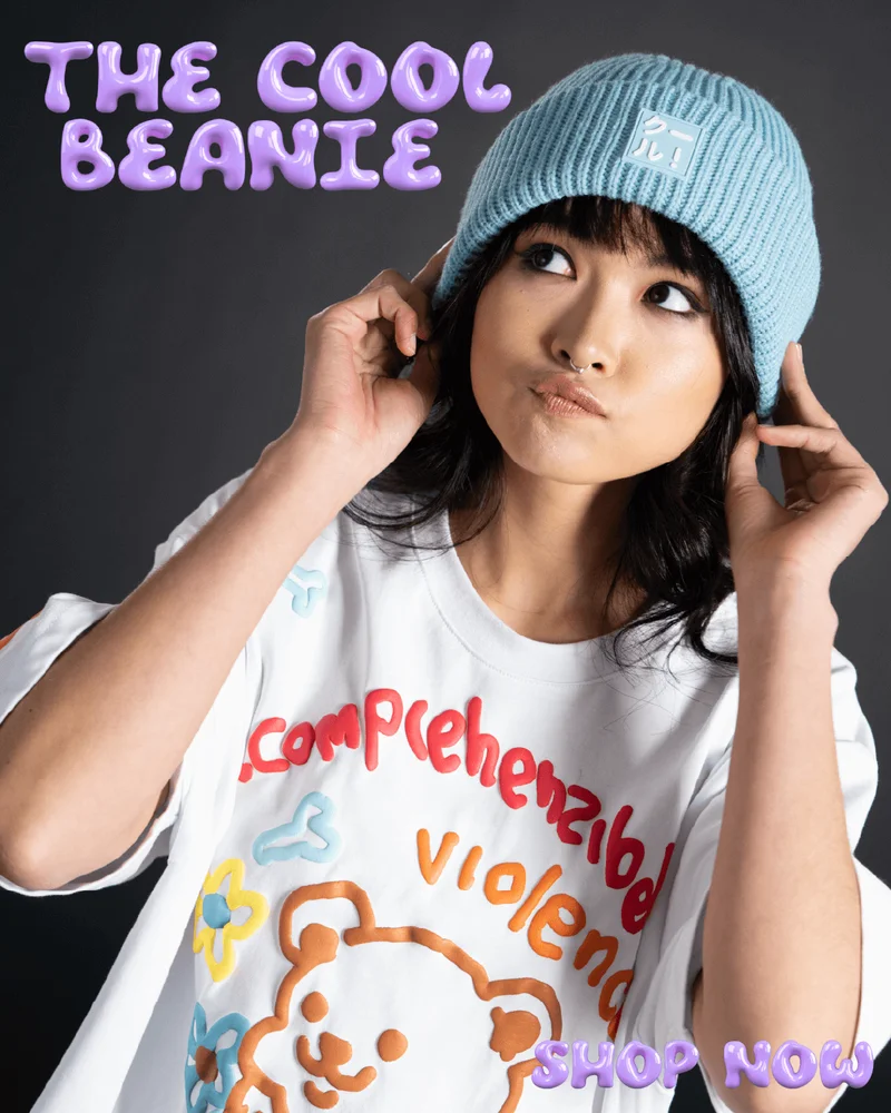 The Cool Beanie. Shop Now. [image of a young woman wearing a light blue beanie posing in front of a black background]