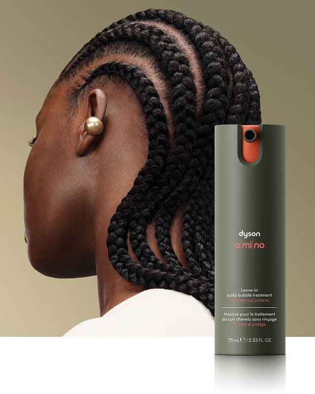 Dyson Amino leave-in scalp bubble treatment in front of a model with nourished hair.