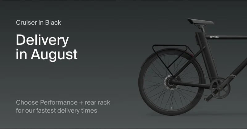 A graphic showing text alongside a Cowboy Classic. Text reads: Cruiser in Black. Delivery in August. Choose Performance + rear rack  for our fastest delivery times"