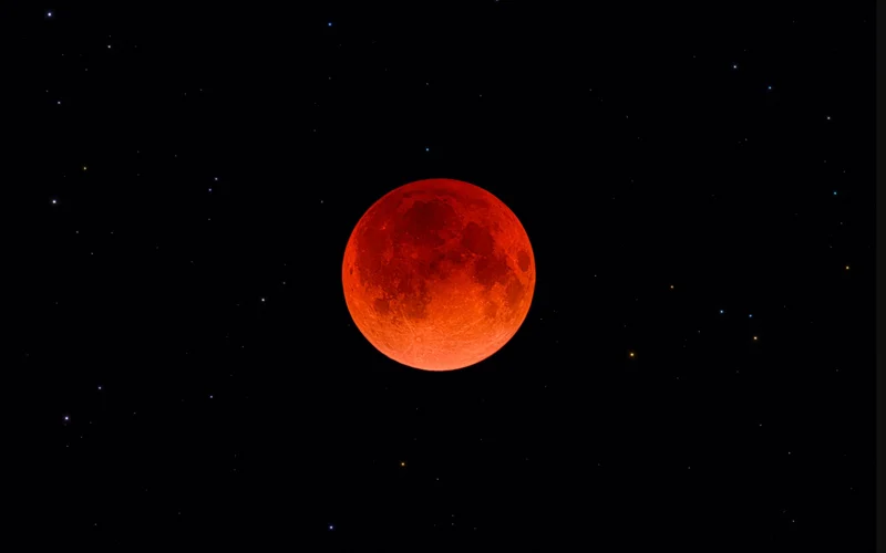 During a total lunar eclipse (one in 2022 seen here in Portugal), light is refracted through Earth's atmosphere, casting a fiery glow on the moon's surface.